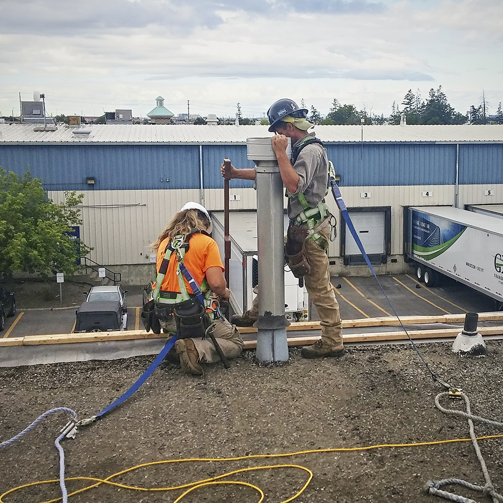 Professional Commercial Roofers Installing Safety Equipment