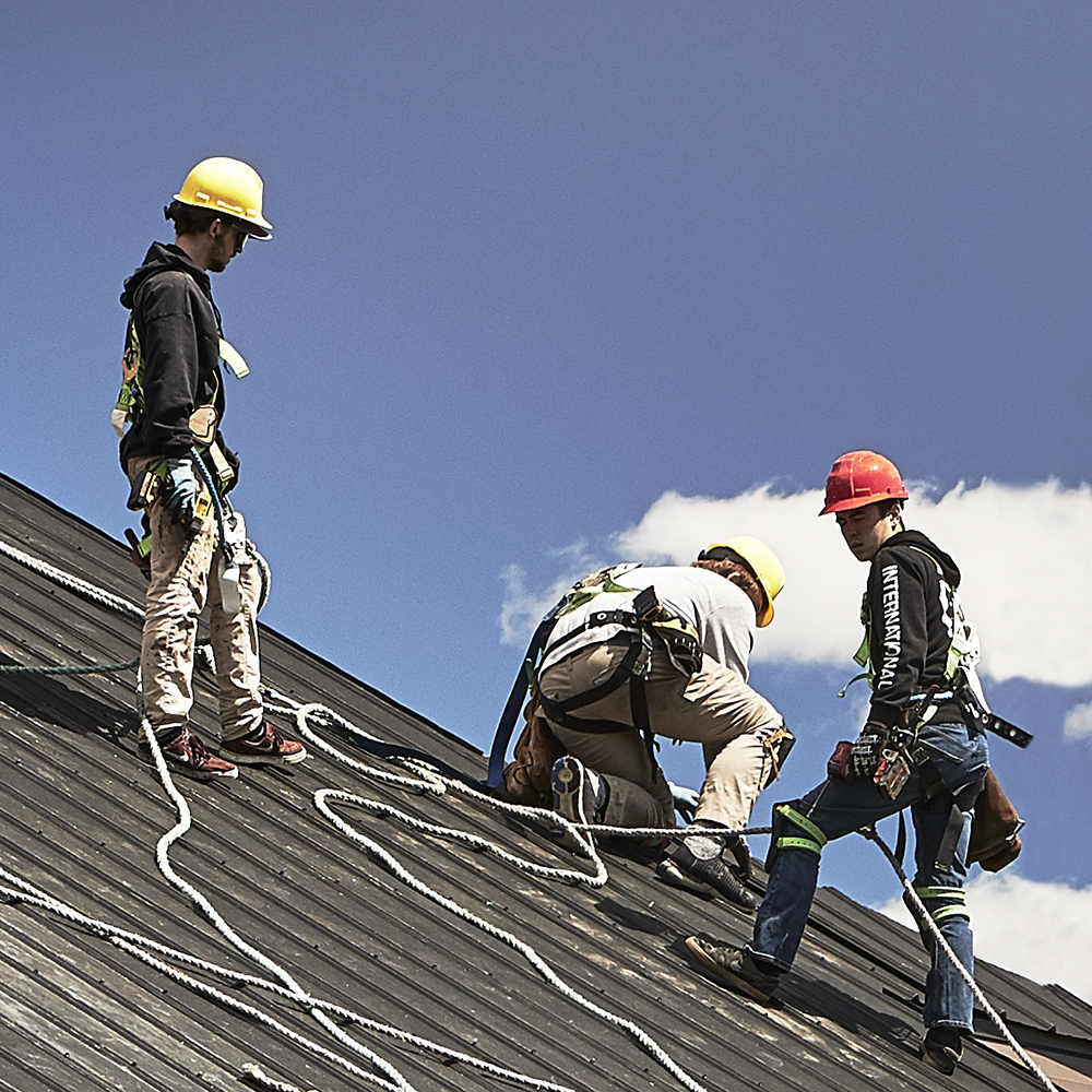 Professional Commercial Roofers Working Safely At Heights