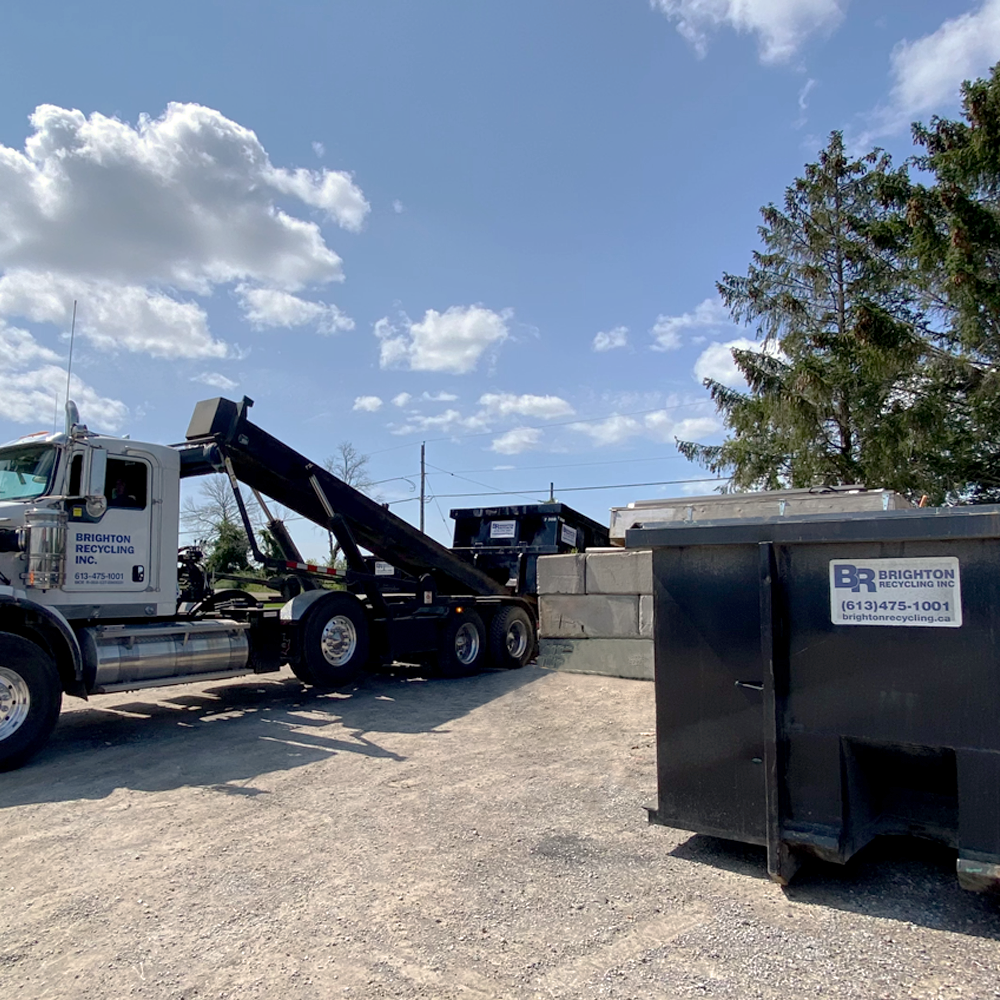 Recycling Truck Removing Bins Of Commercial Roofing Materials